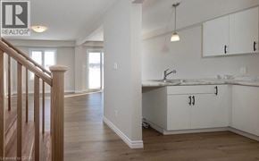 Stratford townhouse for rent - A realtor logo is on a wall in a kitchen.