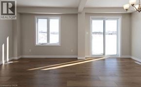 Stratford townhouse for rent - A spacious room with wooden floors and large windows.