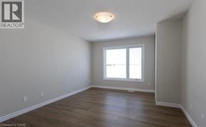 Stratford townhouse for rent - A room with a window and wooden flooring.