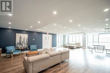 Toronto (Niagara) condo for rent - A spacious living room with a large couch and a painting on the wall.