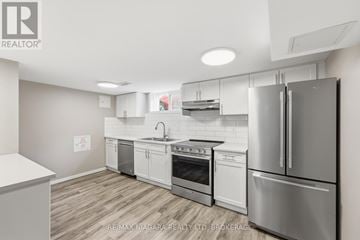 St. Catharines (Carlton/Bunting) apartment for rent - A kitchen with stainless steel appliances and white cabinets.