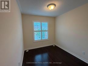 Markham (Cathedraltown) townhouse for rent - A room with a window and wooden flooring.