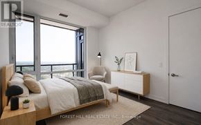 Vaughan (Beverley Glen) condo for rent - A bedroom with a large bed and a view of the ocean.
