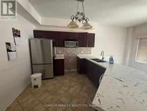 Barrie (Ardagh) apartment for rent - A kitchen with a refrigerator, microwave, and sink.