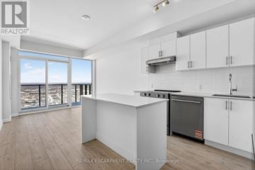 Vaughan (Vellore Village) condo for rent - A modern kitchen with white cabinets and a stainless steel oven.