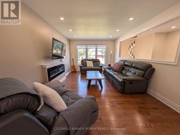 Georgina (Keswick South) apartment for rent - A living room with a grey couch and a flat screen TV.
