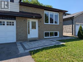 Georgina (Keswick South) apartment for rent - A house with a white garage door and a brown brick wall.