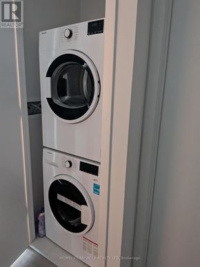 Mississauga (City Centre) condo for rent - Two white front loading washing machines in a brokerage.