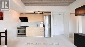 Toronto (Stonegate-Queensway) condo for rent - A kitchen with a stove top oven and a refrigerator.