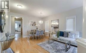 Brampton (Bram East) apartment for rent - A well-lit living room with a dining area in the background.