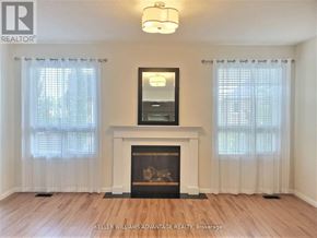 Mississauga (Churchill Meadows) apartment for rent - A living room with a fireplace and a mirror above it.
