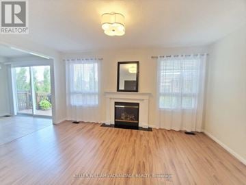 Mississauga (Churchill Meadows) apartment for rent - A living room with a fireplace and a painting on the wall.