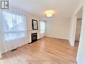 Mississauga (Churchill Meadows) apartment for rent - A room with a fireplace and a mirror on the wall.