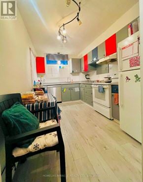 Guelph (Willow West/Sugarbush/West Acres) condo for rent - A kitchen with a white fridge and wooden floors.