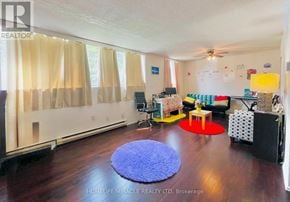 Guelph (Willow West/Sugarbush/West Acres) condo for rent - A living room with a blue rug and a red rug on the floor.