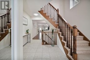 Cambridge apartment for rent - A hallway with a staircase and a plant on the side table.