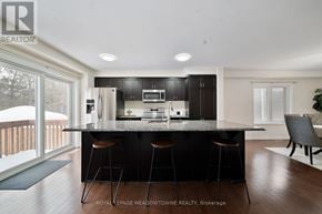 Cambridge apartment for rent - A modern kitchen with a bar area and a dining table.