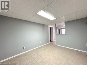 Windsor apartment for rent - A spacious room with tile flooring and a doorway leading to another room.