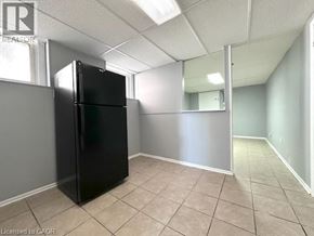 Windsor apartment for rent - A black refrigerator in a room with a mirror on the wall.