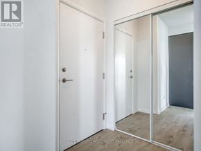 Vaughan (Concord) condo for rent - A white door with a mirror on the wall.