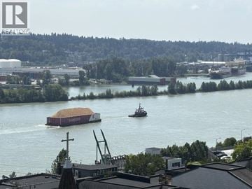 New Westminster apartment for rent - A barge with the word "FERRY" on it is floating on a river.