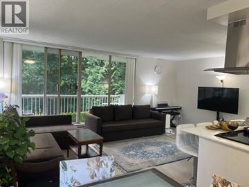 North Vancouver apartment for rent - A living room with a brown couch and a glass table.