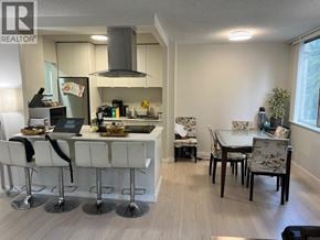 North Vancouver apartment for rent - A kitchen with white chairs and a table.