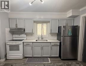 Windsor apartment for rent - A kitchen with white appliances and cabinets.