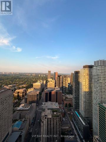 Toronto (Church-Yonge Corridor) condo for rent - A cityscape with tall buildings and a clear sky.