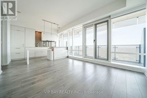Toronto (Church-Yonge Corridor) condo for rent - A spacious room with a kitchen area and a view of the bay.