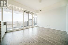 Toronto (Church-Yonge Corridor) condo for rent - A spacious room with a large window and sliding glass doors.