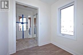 Toronto (Clairlea-Birchmount) townhouse for rent - A white room with a door and a window.