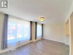 Toronto (Clairlea-Birchmount) townhouse for rent - A room with a large window and a sliding door.