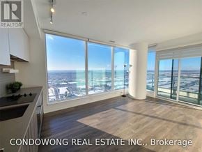 Vaughan (Vaughan Corporate Centre) condo for rent - A spacious room with a view of the cityscape through large windows.