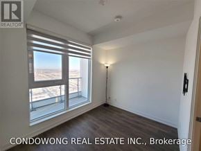 Vaughan (Vaughan Corporate Centre) condo for rent - A room with a large window overlooking a cityscape.