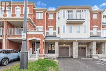Brampton (Heart Lake East) townhouse for rent - A blue car is parked in front of a brick building with a sign that reads "REALTOR".