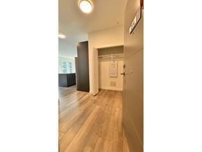 Langley apartment for rent - A hallway with a wooden floor and a white door.