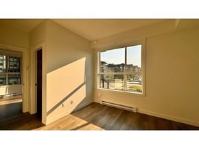 Langley apartment for rent - A room with a large window and a wooden floor.