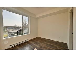 Langley apartment for rent - A room with a window overlooking a parking lot.