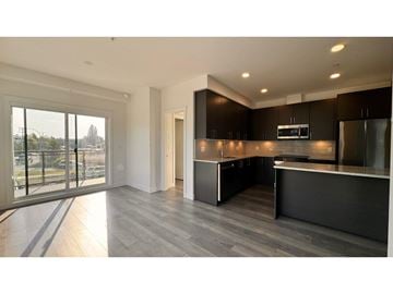 Langley apartment for rent - A modern kitchen with dark wood cabinets and a large island.