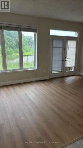Niagara Falls (Brown) apartment for rent - A room with a wooden floor and a sliding glass door.