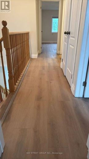 Niagara Falls (Brown) apartment for rent - A hallway with wooden floors and white walls.