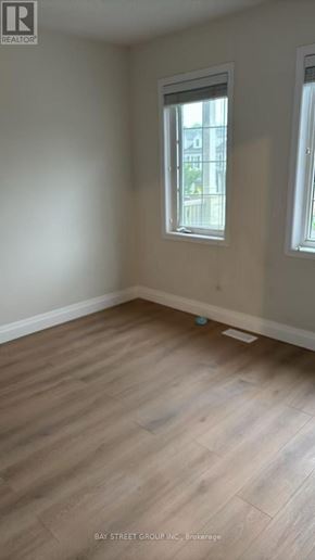 Niagara Falls (Brown) apartment for rent - A room with wooden flooring and a window.