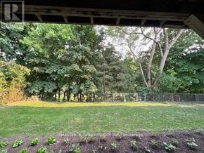 Toronto (Hillcrest Village) apartment for rent - A garden with a fence and trees in the background.