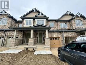 Kitchener townhouse for rent - A grey car is parked in front of a house.