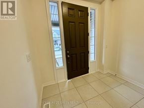 Kitchener townhouse for rent - A room with a brown door and a tiled floor.