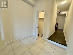 Kitchener townhouse for rent - A white room with a doorway leading to another room.