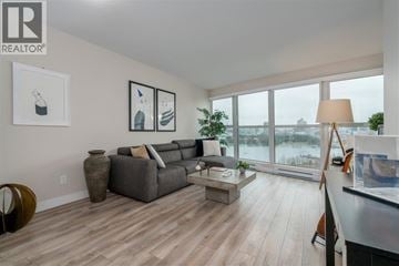 Vancouver apartment for rent - A living room with a grey couch and a coffee table.