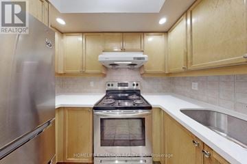 Toronto (Willowdale East) condo for rent - A kitchen with wooden cabinets and stainless steel appliances.