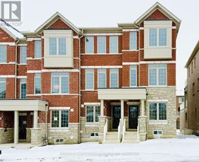 Pickering townhouse for rent - A large red brick building with a white trim and a small porch.